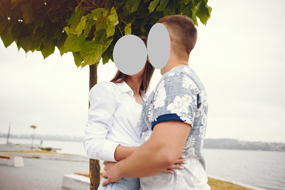 Cute couple walking near water. Girl in a white shirt. Pair by the river